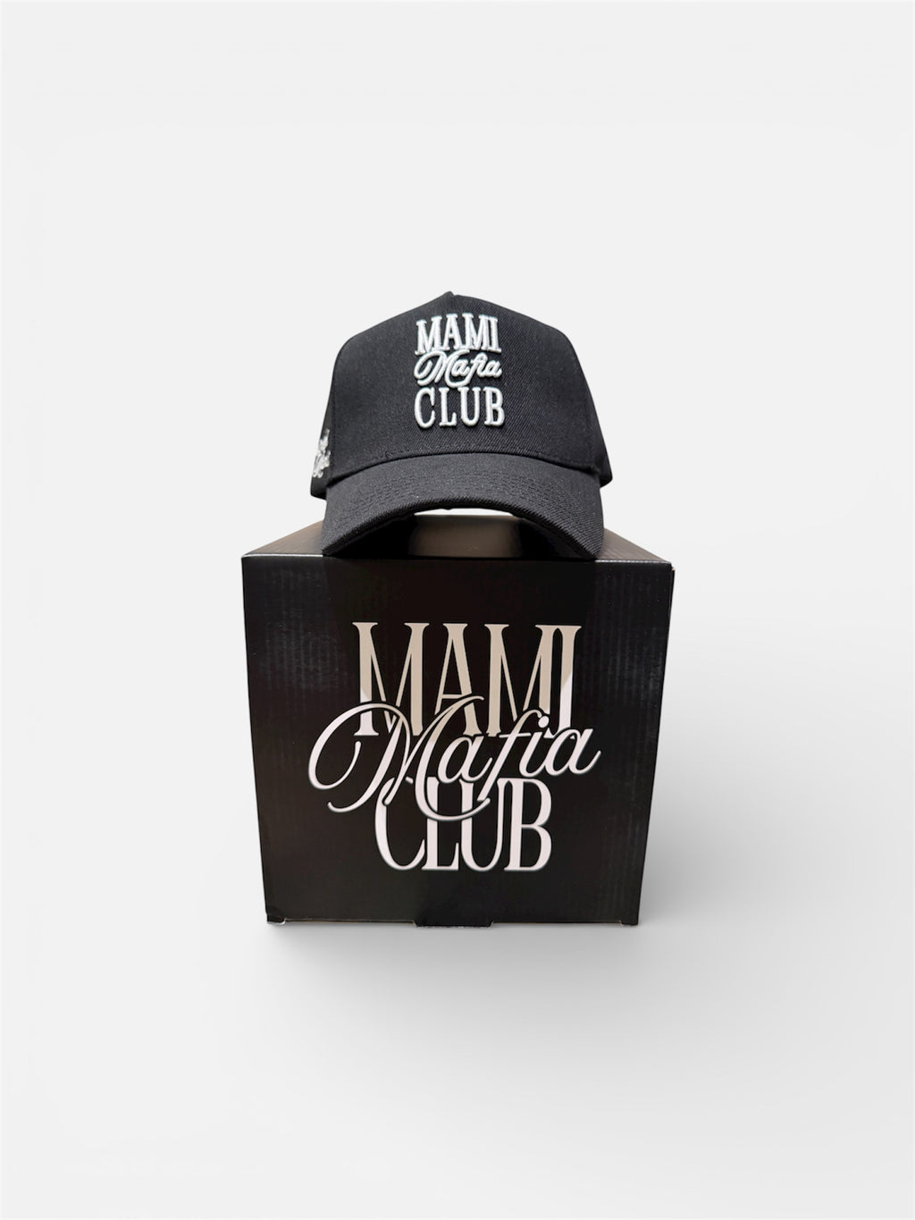 Black Mami Mafia Club trucker hat displayed on branded box